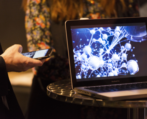 Two people with a laptop and a phone.