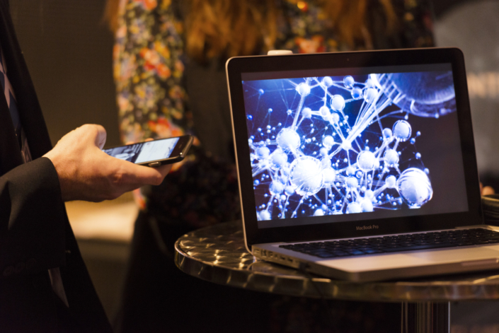 Two people with a laptop and a phone.