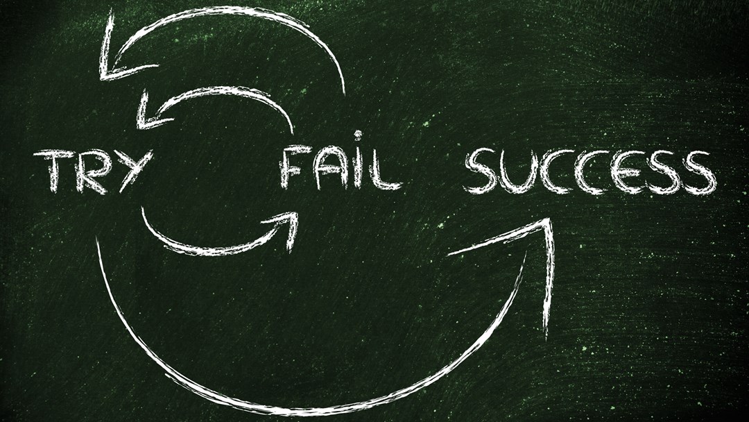 Blackboard with words "try", "fail", "success" and arrow symbols