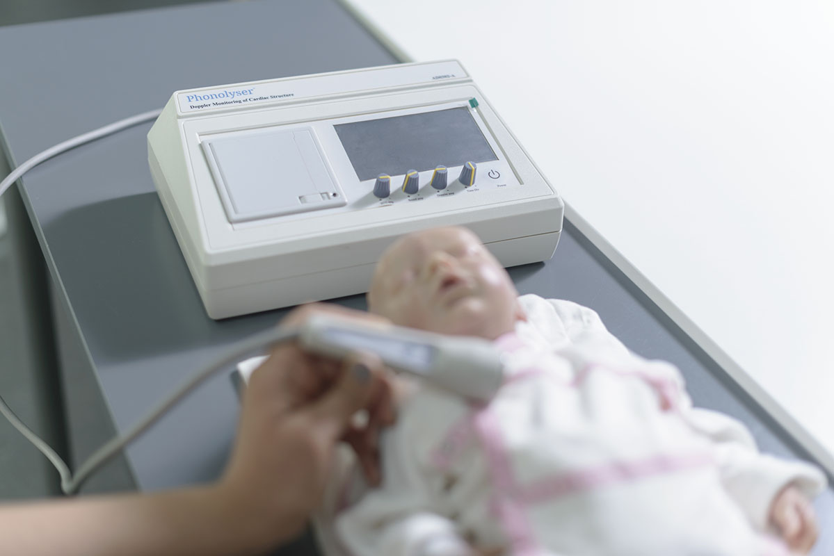Examining a baby doll with Phonolyser's smart heart analyzer