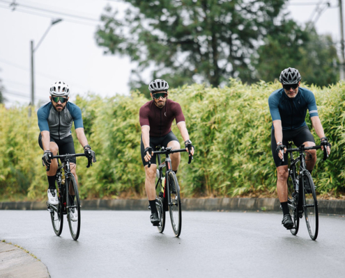Three men cycling on a road