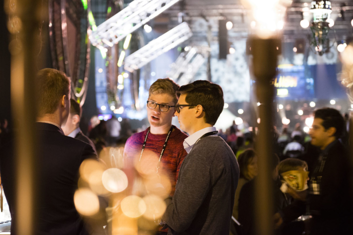 Three people discussing in Slush exhibition