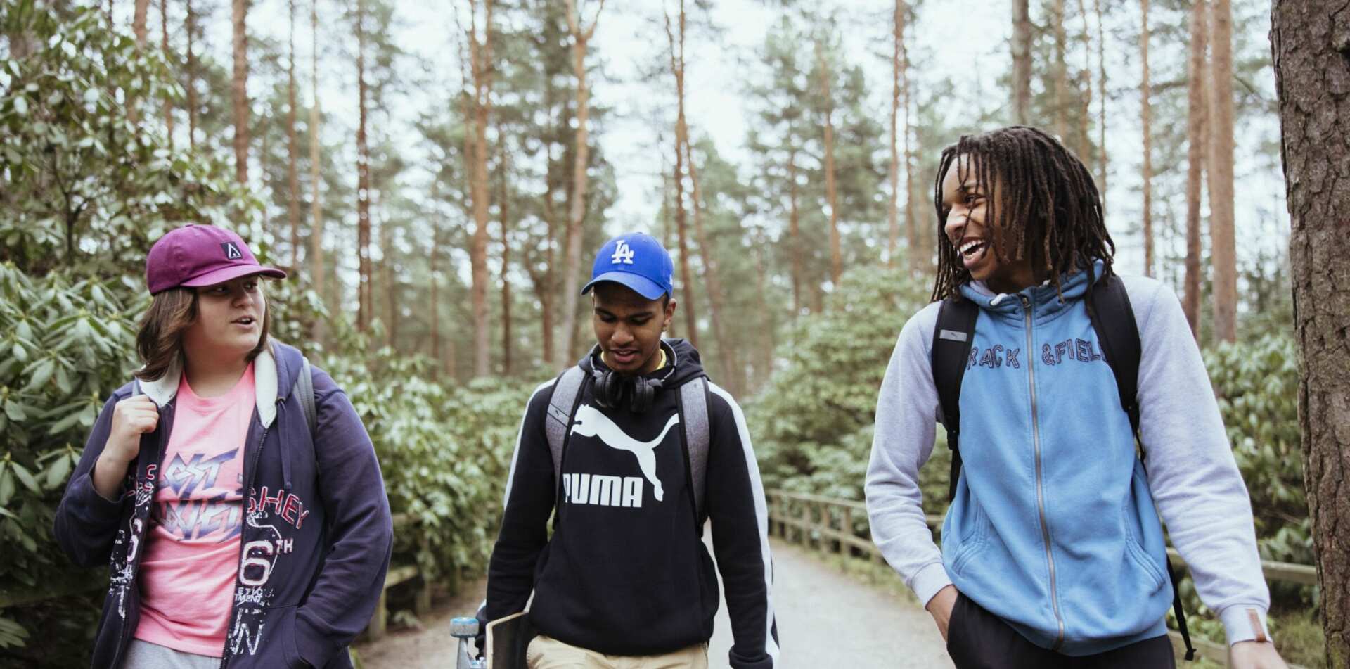 Three young people walking in nature
