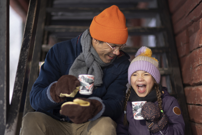 Man and child drinking hot chocolate