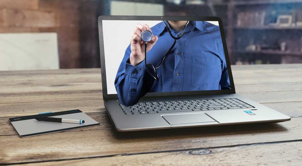 Laptop with a person and a stethospope on the screen