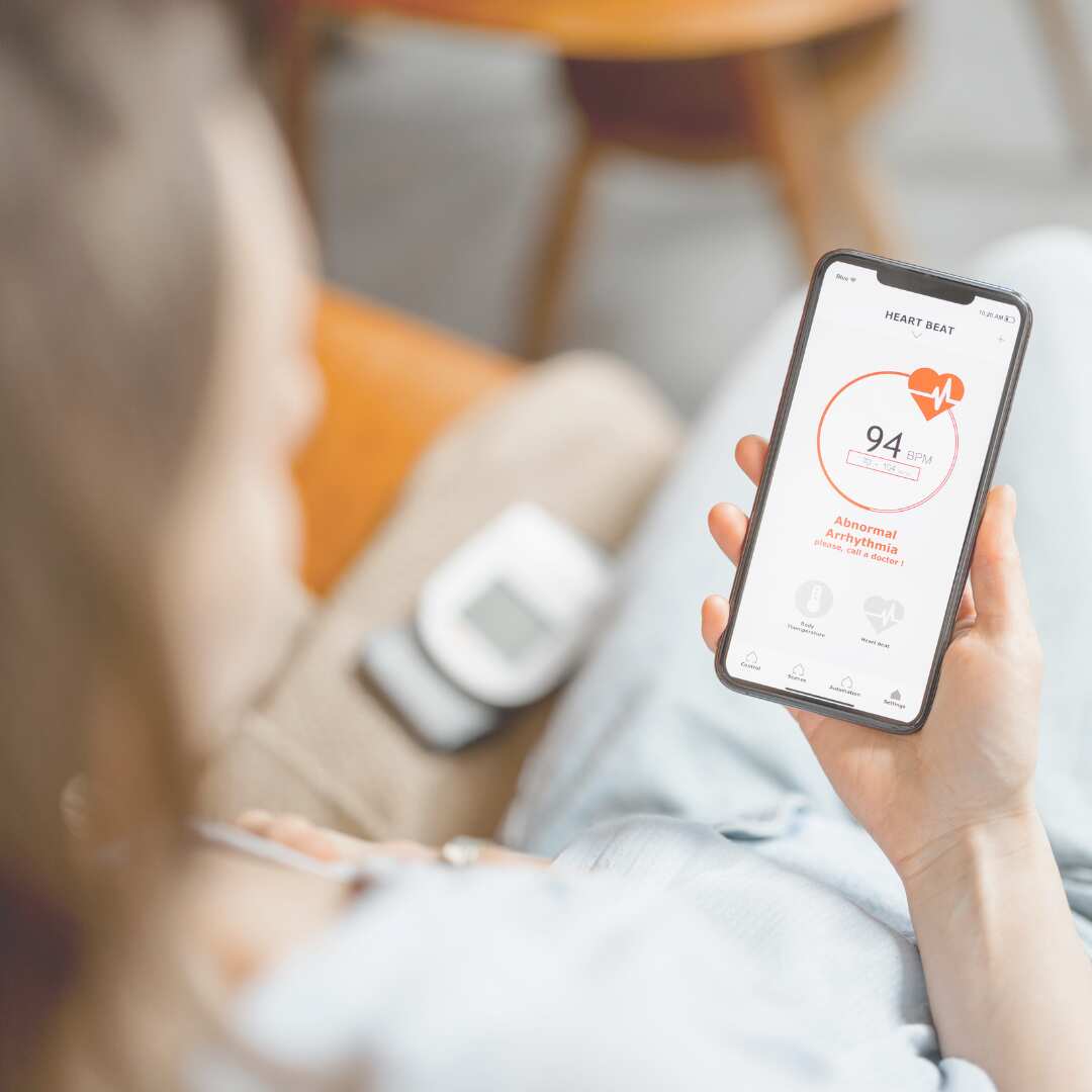 A woman holding a phone, including information on heart health